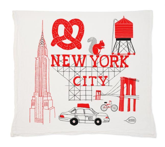 Decorative pillow with New York City illustrations and text.