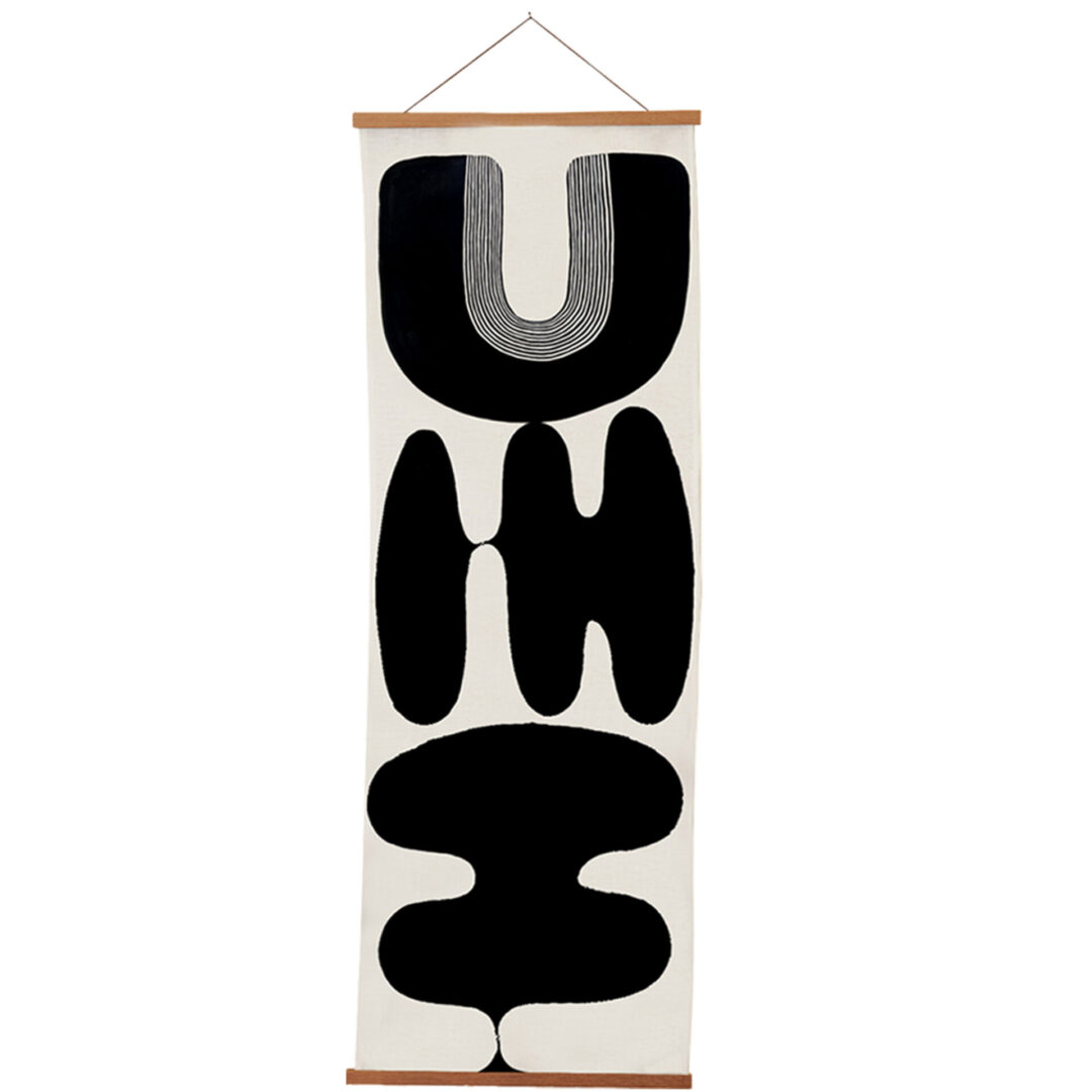 Abstract black shapes arranged vertically on a white hanging canvas.