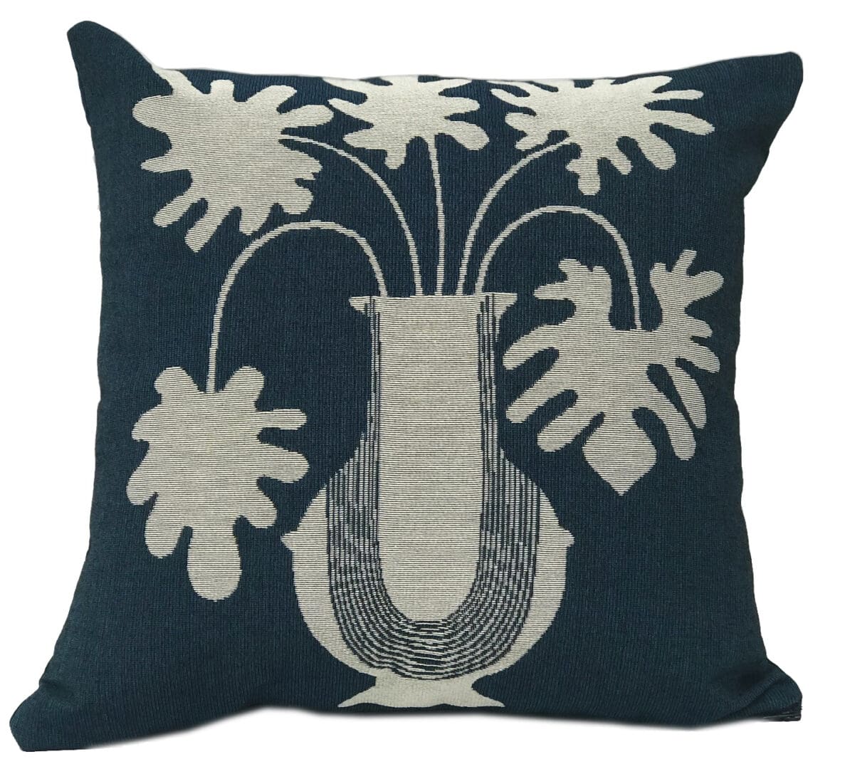 Decorative pillow with white floral embroidery on dark blue fabric.