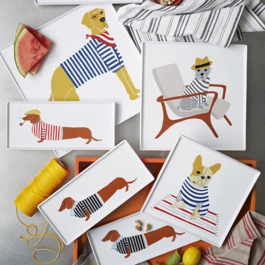 Illustrations of dogs wearing various outfits on paper.