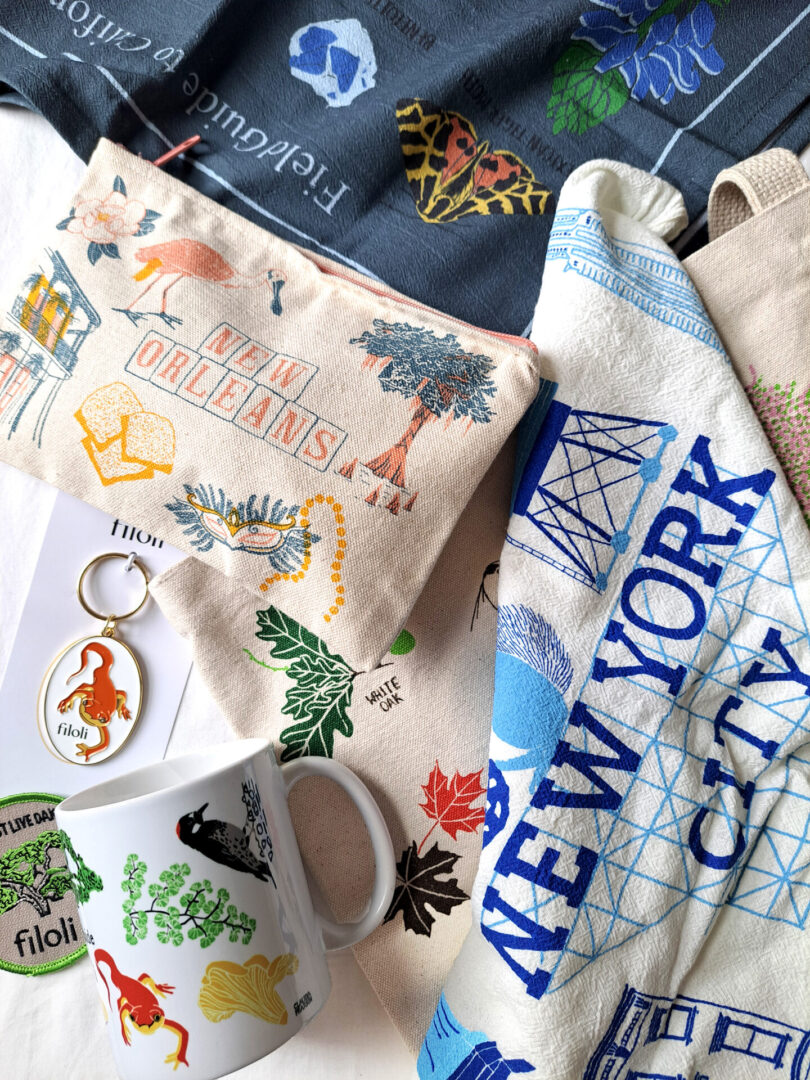 A collection of travel-themed items including a New York City tote and a map pouch.
