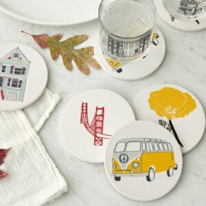 Coasters with artistic designs on a white table.