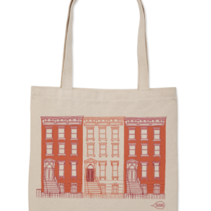 Beige tote bag with red cityscape design and text.