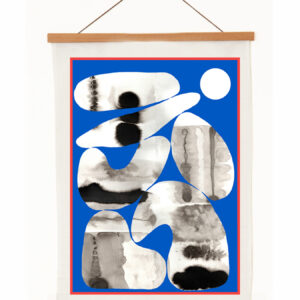 Abstract black and white shapes on a blue background in a framed hanging artwork.
