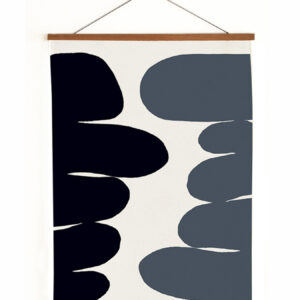 Abstract black and gray shapes on a hanging wall art piece.