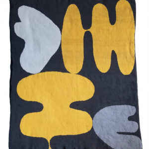 Abstract rug with yellow, gray, and white shapes on a dark background.