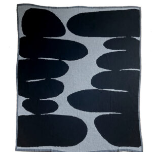 Abstract black shapes on white background resembling stones or shadows.