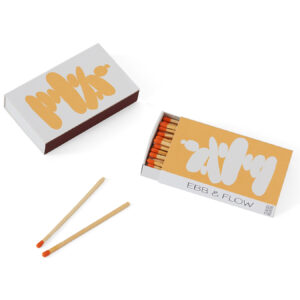 Two matchboxes with scattered wooden matches on a white surface.