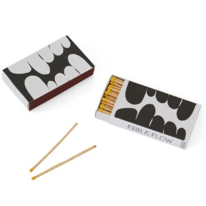 Two matchboxes with black and white abstract designs and two matches.