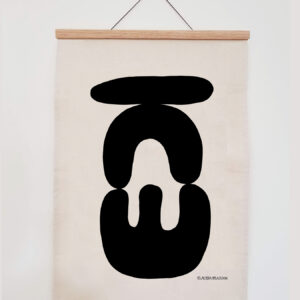 Abstract black shapes on a hanging white canvas.