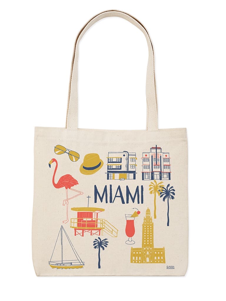 A beige tote bag with colorful Miami-themed illustrations and text.
