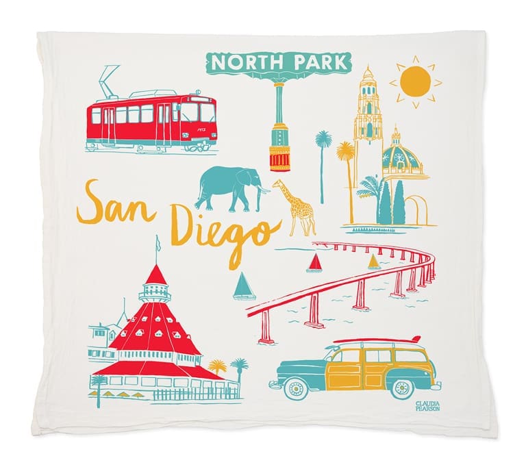 Illustrated San Diego landmarks and icons on a decorative cloth.