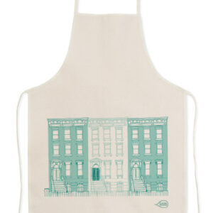 Beige apron with teal building illustrations on the front.