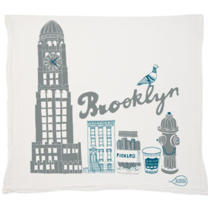 Decorative pillow featuring Brooklyn-themed illustrations in gray and blue.