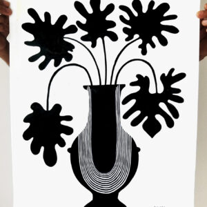 Black floral silhouette in a stylized vase on white paper.