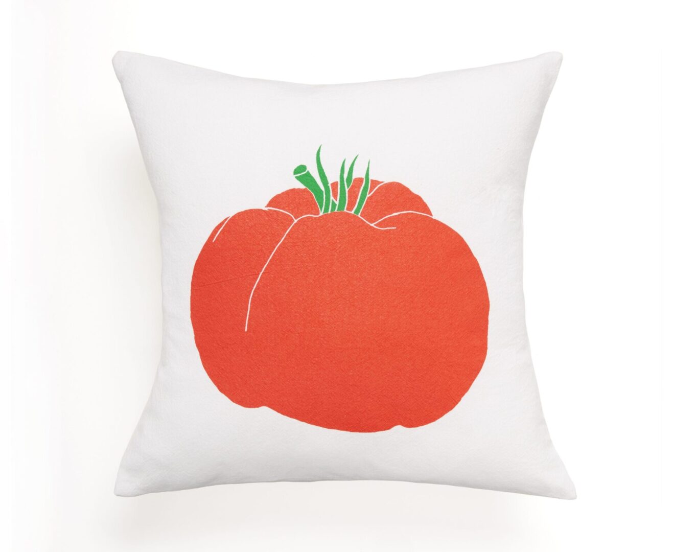 White pillow with a red tomato illustration.