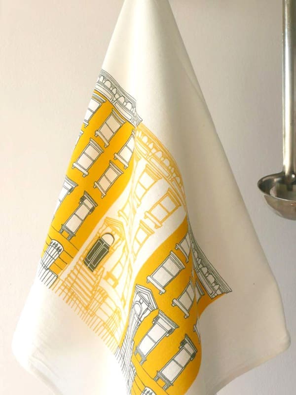 A yellow and white patterned towel hanging on a hook.